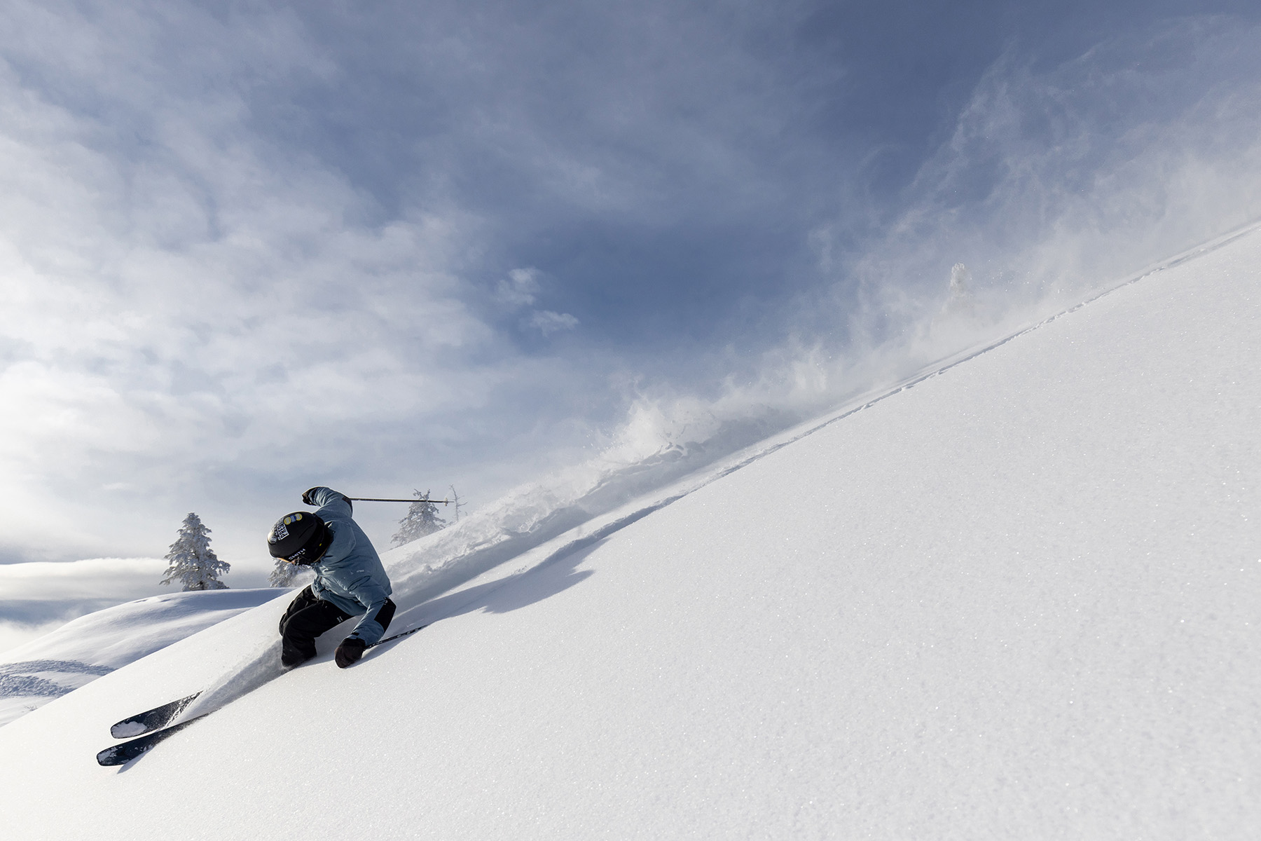 skier rides past camera down a snowy slope at Bogus Basin Mountain Recreation Area near Boise, ID
